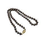 A strap of pearls on 18ct gold clasp