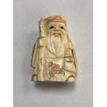 A carved bone Chinese netsuke - village elder with staff