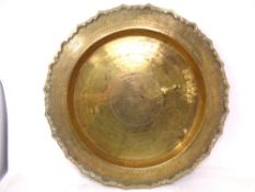 An Indian brass scalloped edge dish (diameter 47cm).