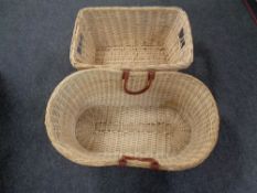 Two wicker log baskets one with leather handles.