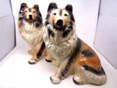 A pair of ceramic fireside dogs CONDITION REPORT: Each with cracks to fore-legs.