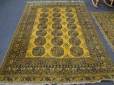 An Afghan Bokhara carpet on gold ground 285cm by 208cm