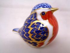 A Royal Crown Derby china paperweight of a Robin with gold stopper.