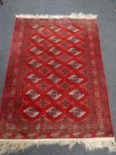A Bokhara rug on red ground 171cm by 122cm