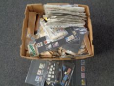 A box containing hundreds of loose British and world stamps.
