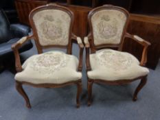 A pair of continental carved beech salon armchairs in tapestry fabric