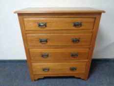 An Edwardian oak four drawer chest.