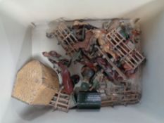 A box containing a quantity of vintage lead animal figures and farming accessories.