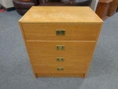 A continental teak effect chest of four drawers