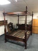 An impressive Victorian style 4'6" four poster bed on claw and ball feet.