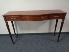A Chapman's Siesta Regency style bow fronted hall table, fitted with a central drawer.