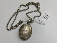 An antique white metal locket on long guard chain