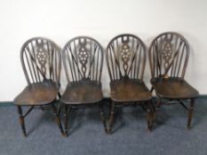 A set of four wheel back kitchen chairs.