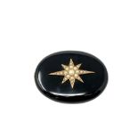 A Victorian black agate memorial brooch inset seed pearls with gold mounted reverse.
