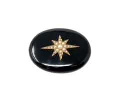 A Victorian black agate memorial brooch inset seed pearls with gold mounted reverse.