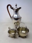 A silver plated claret jug with acorn finial together with a further plated milk jug and sugar