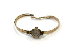 A 9ct gold lady's wristwatch retailed by Garrard, 14.3g.