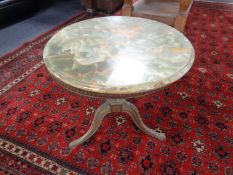 A gilt and onyx occasional table.