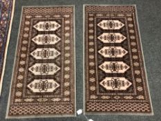 A pair of machined Afghan design rugs 61 cm x 119 cm