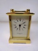 A heavy brass cased battery operated mantel clock by Taylor & Bligh of London (height 15cm).