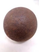 An antique cast iron cannonball.