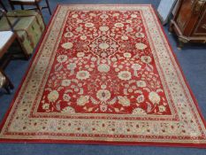 A machine made woolen Persian design carpet on red ground,