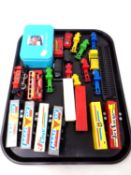 A tray containing die cast vehicles including Lledo and Hotwheels, a miniature train set in a tin,