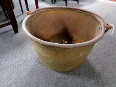 A 19th century copper cooking pot with cast iron handles (diameter 57cm).
