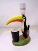 A Guinness How Good to be a Toucan china table lamp (height 27cm).