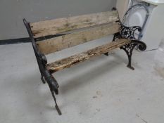 A wooden plank and cast iron garden bench.