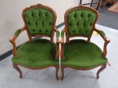 A pair of carved beech framed French style salon armchairs upholstered in green dralon.