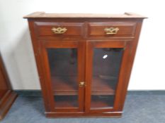 A part 19th century mahogany double door bookcase fitted with two drawers above.