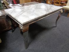 A contemporary faux marble topped table on chrome legs (length 150cm).
