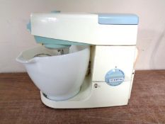 A vintage Kenwood food mixer with accessories.