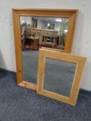 A pine framed mirror together with a contemporary oak framed mirror.
