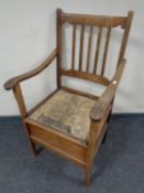 An Edwardian beechwood commode chair.