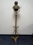 An antique brass rise and fall standard oil lamp