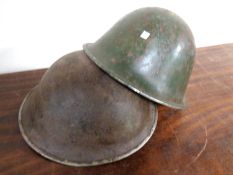 Two World War II tin helmets.