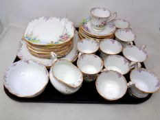 A set of 24 pieces of Paragon Merrivale bone tea china with hand painted detail.