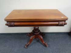 A Victorian mahogany turnover top tea table on four way pedestal.