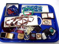A tray containing vintage costume jewellery including beaded necklaces, brooches,