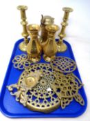A tray containing antique and later brass ware including trivets, vases, a pair of candlesticks etc,