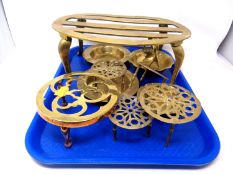 A tray containing antique and later brass ware including trivets, ashtray, basket etc.