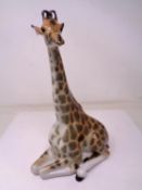 A USSR china figure of a seated giraffe (height 29.5cm).