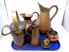 A tray containing antique and later brass and copper ware including jugs, a teapot etc.