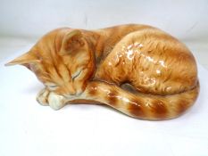 A Goebel figure of a sleeping cat (height 9cm).
