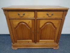 An American style pine double door sideboard fitted with two drawers above (width 116cm).
