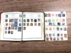 An album and two sheets of antiquarian world stamps.
