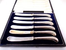 A boxed set of six silver handled butter knives, Sheffield marks.