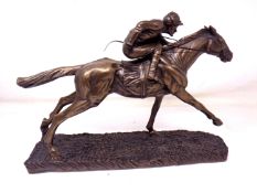 A cast resin figure of a horse and jockey (height 17.